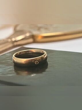 Two Toned 14k Gold Band with Single Diamond chip Accent.